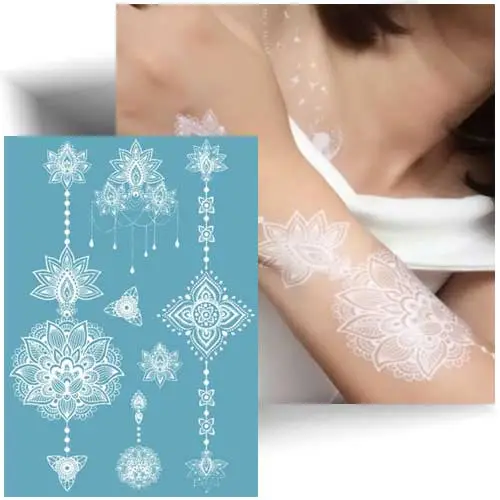 Planche de tatouage temporaire mandala blanc avec 6 motifs fins style dentelle, idéale pour mariage et look estival sur peau hâlée.